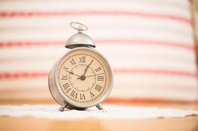 a silver alarm clock sitting on a table at Apartments Petacova Hiša in Kranjska Gora