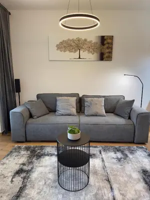 a living room with a couch and a table at Riverstone Retreat Bovec in Bovec