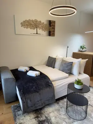a living room with a couch and a tree picture on the wall at Riverstone Retreat Bovec in Bovec