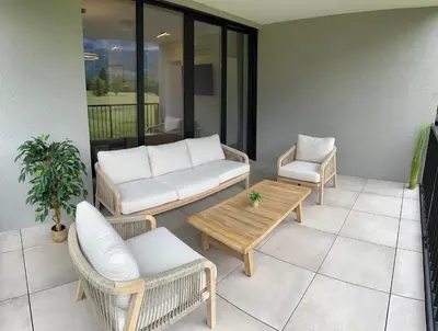 a living room with a couch and a table and chairs at Riverstone Retreat Bovec in Bovec