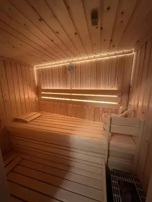 a small wooden sauna with a bench in it at Riverstone Retreat Bovec in Bovec