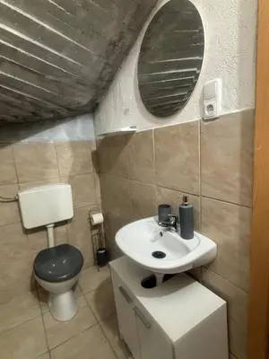 a bathroom with a sink and a toilet and a mirror at Studio Old Town in Maribor