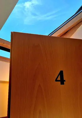 a wooden door with the number four on it at Bled Lesce station rooms and depo in Lesce