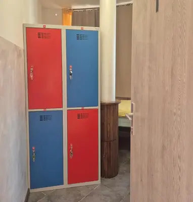 a pair of lockers with red and blue doors in a room at Bled Lesce station rooms and depo in Lesce