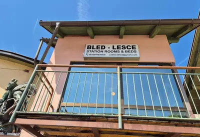 a sign on the side of a building at Bled Lesce station rooms and depo in Lesce