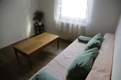 a living room with a couch and a wooden table at Podgozd Holiday House in Trnovo