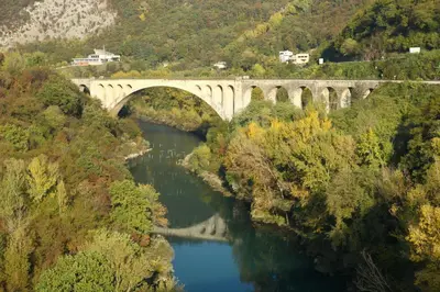 a bridge over a river in a valley at Podgozd Holiday House in Trnovo