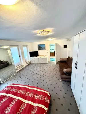 a living room with a red bed and a couch at Vila Giovana in Vipava