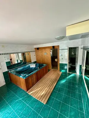 a bath tub in a room with green tiles at Vila Giovana in Vipava