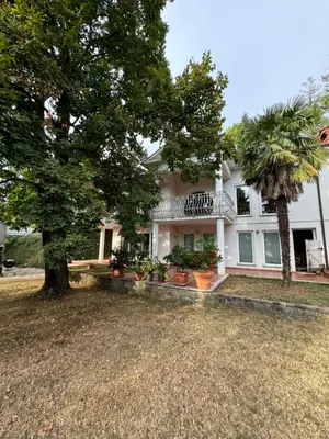 a white house with a tree in front of it at Vila Giovana in Vipava