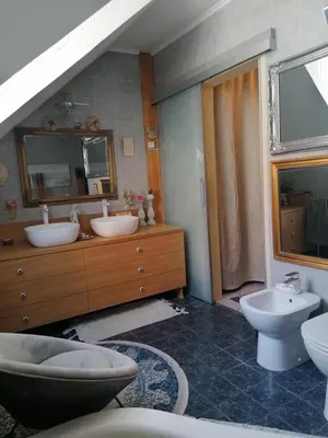 a bathroom with two sinks and two toilets at Unique apartma in the city center in Ljubljana