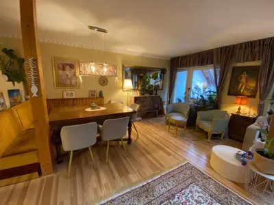 a living room with a table and chairs and a couch at Unique apartma in the city center in Ljubljana
