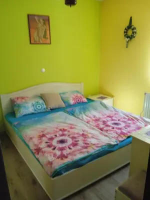 a bedroom with a bed with a flower blanket at Apartmaji Stara Šola in Bohinjska Bistrica