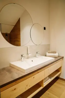 a bathroom with a white sink and a mirror at Sobe rooms JELEN JELENOV GREBEN in Podčetrtek