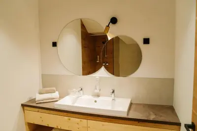 a bathroom with a sink and a mirror at Sobe rooms JELEN JELENOV GREBEN in Podčetrtek