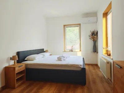 a bedroom with a bed with two towels on it at Wellness soba Amaris in Benedikt v Slovenskih Goricah
