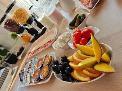 a table topped with bowls of fruit and plates of food at Wellness soba Amaris in Benedikt v Slovenskih Goricah