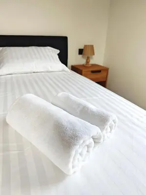 two white towels are sitting on a bed at Wellness soba Amaris in Benedikt v Slovenskih Goricah