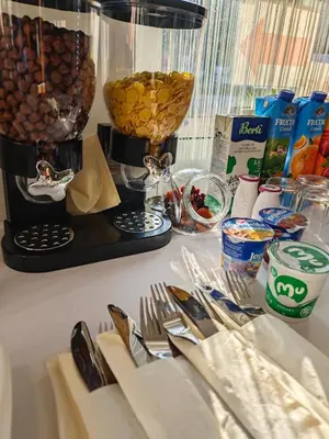 a table with utensils and other food on it at Wellness soba Amaris in Benedikt v Slovenskih Goricah