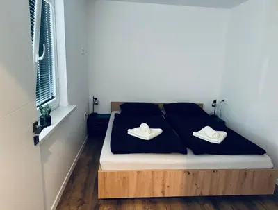 a bedroom with a bed with two towels on it at Rebecca's Apartment in Radovljica