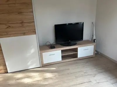 a flat screen tv sitting on top of a entertainment center at Apartment Pr`Jurčk Bled in Bled