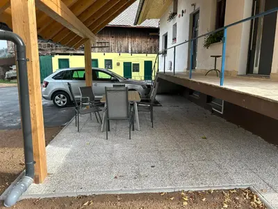 a patio with chairs and a table and a car at Apartment Pr`Jurčk Bled in Bled