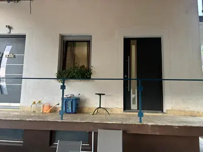 a balcony of a building with a table and a window at Apartment Pr`Jurčk Bled in Bled