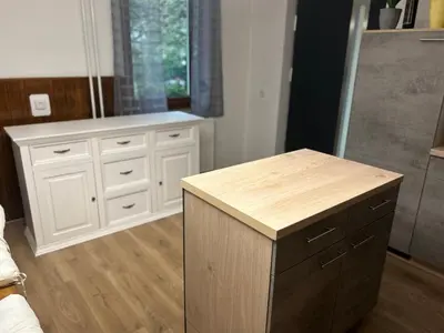 a kitchen with white cabinets and a wooden counter at Apartment Pr`Jurčk Bled in Bled