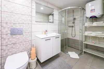 a bathroom with a shower and a toilet and a sink at The LOFT Ljubljana in Ljubljana