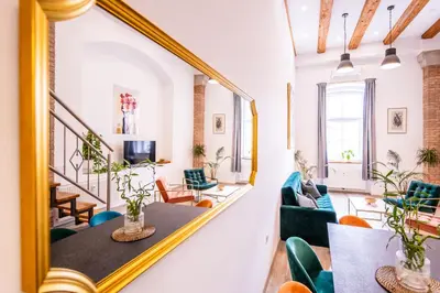 a mirror in a room with a table and chairs at The LOFT Ljubljana in Ljubljana