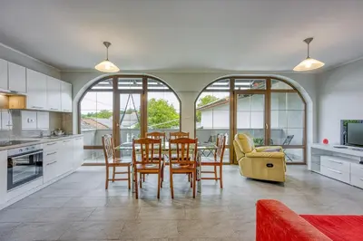 a kitchen and dining room with a table and chairs at Cesar's Karst Estate in Sežana