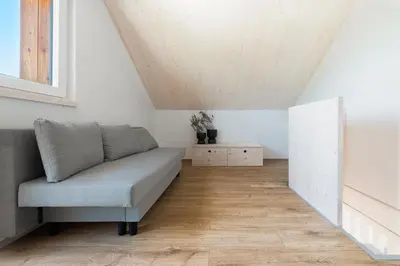 a living room with a couch and a table at Cottage Retreat with Hot Tub & Sauna in Zgornja Kungota