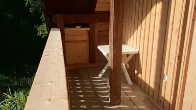 a bench sitting on the side of a building at Apartment Markič in Bohinj