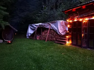 a tent with lights in a yard at night at Ski Cottage in Semič