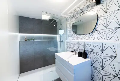 a bathroom with a white sink and a mirror at Mojca's nest apartment in Mengeš