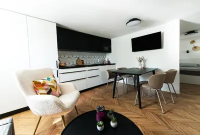 a kitchen and living room with a table and chairs at Mojca's nest apartment in Mengeš