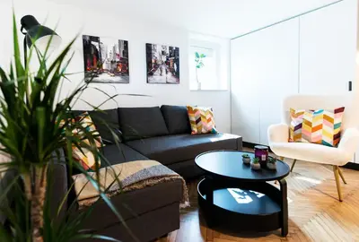 a living room with a couch and a table at Mojca's nest apartment in Mengeš