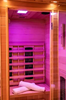 a purple room with two towels on a shelf at Wellness hiša Jelenov Grič in Mala Nedelja
