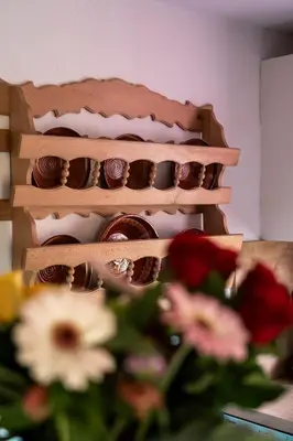 a shelf of cupcakes with flowers in front of them at Wellness hiša Jelenov Grič in Mala Nedelja