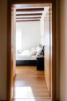 a door leading to a bedroom with a bed at 4 TeTE in Vrhpolje