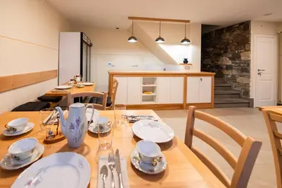 a kitchen and dining room with a table and chairs at 4 TeTE in Vrhpolje