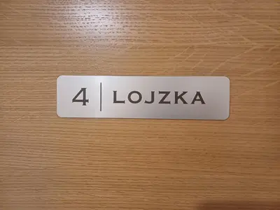 a sign on a wooden door that says lockka at 4 TeTE in Vrhpolje