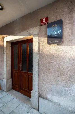 a sign on the side of a building with a door at 4 TeTE in Vrhpolje