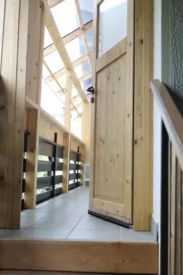 an open wooden door in a building with a staircase at Apartma Saša in Zgornje Jezersko
