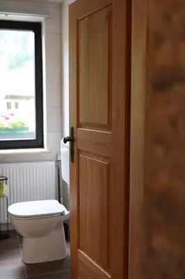 an open door to a bathroom with a toilet at Apartma Saša in Zgornje Jezersko