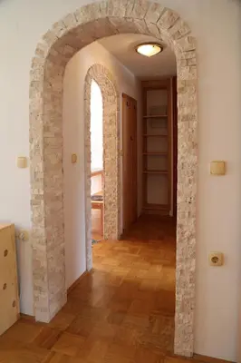 a hallway with an archway in a room at Apartma Saša in Zgornje Jezersko