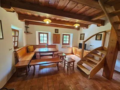a living room with a table and a dining room at Mežnarija - Cerovec in Dolenjske Toplice