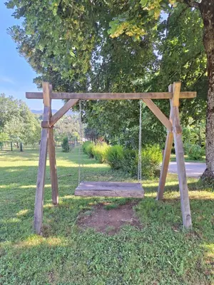 a swing set in the grass in a park at Mežnarija - Cerovec in Dolenjske Toplice
