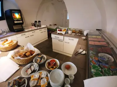 a kitchen with plates of food on a table at Hotel garni Paleta in Škofja Loka