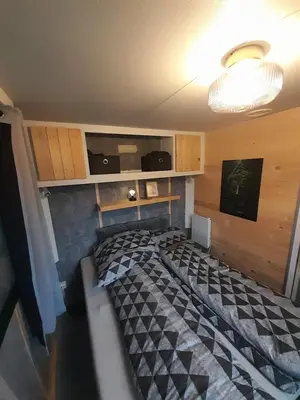 a bedroom with a bed with a checkered bed sidx sidx sidx at Tepe Retreat in Konjšica